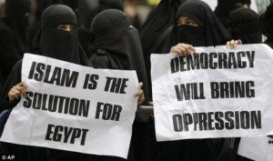 Muslim women hold anti-democracy signs