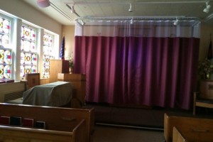 Christian symbols are hidden behind a curtain in this VA chapel.