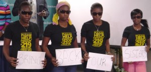 Young Christian women display signs asking for the return of their sisters kidnapped by the Boko Haram