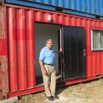 William Murray next to entrance of one of the modified containers used as an office. In some cases these are used as homes for refugees. This is a 20-foot model that is near completion. A 40-foot model is also being prepared.