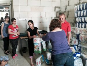 Young Christian mothers stand in line to receive diapers in northern Iraq.