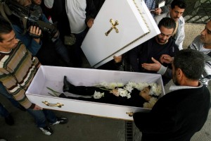 Christian Children killed Nov. 12, 2013 photo shows mourners carrying the coffin of a child killed in a mortar strike at the the Yuhana al-Dimashqi School in Damascus, Syria.