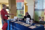An attendee at The Awakening receives information about our Christmas program. Many people visited our exhibit and either took information or spoke with me or with a volunteer.