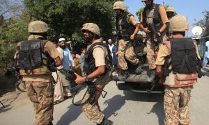 Soldiers arrive after suicide bombers attacked a Christian neighbourhood. Photograph: Fayaz Aziz/Reuters