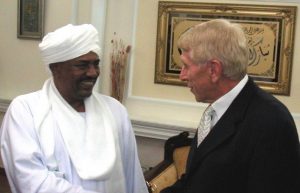 Smiling dictator Omar al-Bashir welcomes William J. Murray to his home (2006).