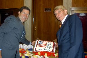Senator Sam Brownback and William J. Murray hold up "In God We Trust" cake to celebrate passage of National Motto Resolution (2006)