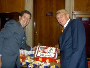 Senator Sam Brownback and William J. Murray hold up "In God We Trust" cake to celebrate passage of National Motto Resolution (2006)