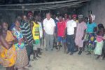 William J. Murray with survivors of the Agatu church massacre. Note that the roof is missing. The inside of the church was set on fire so there are no pews or chairs.